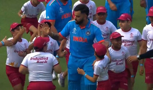 Before India's match against South Africa in 2023, children swarm Virat Kohli with birthday greetings.