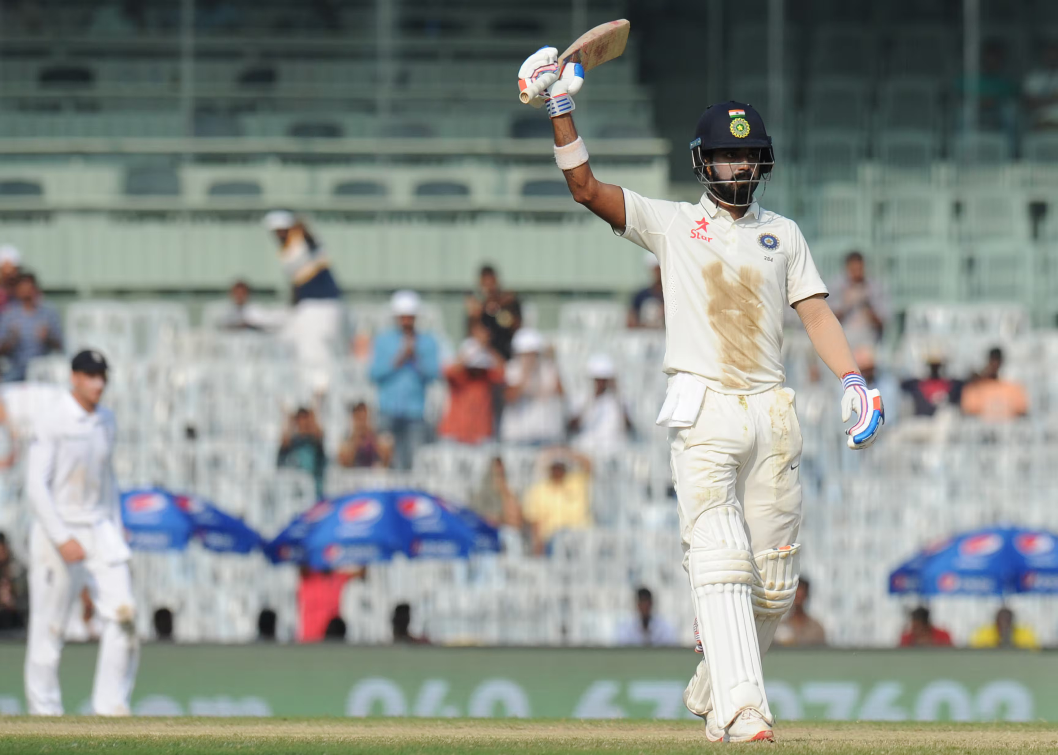 KL Rahul raises his bat as he celebrates after scoring 150 runs during the third day of the fifth Test between India and England at Chennai on December 18 2016